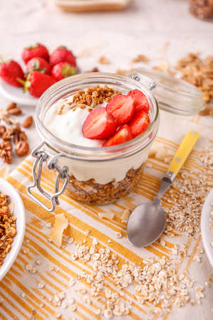 Homemade granola with yogurt and fresh strawberries  for healthy breakfastの写真素材