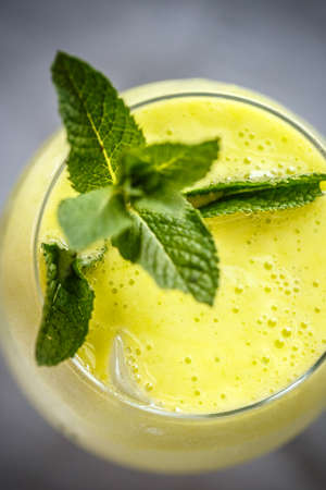 Top view of alcoholic cocktail with egg foam garnished with mintの写真素材