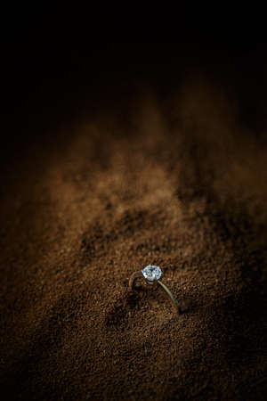 Ring with a polished gemstone on brown background, space for your textの写真素材