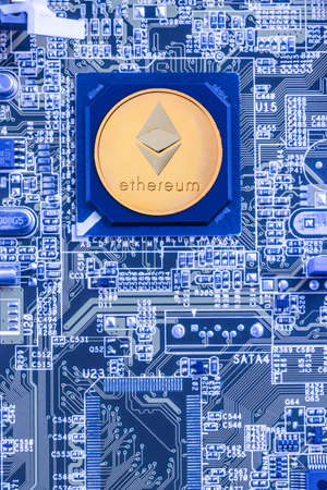 Printed circuit board with a processor and a ethereum symbol. The concept of the mining of crypto-currencyの写真素材