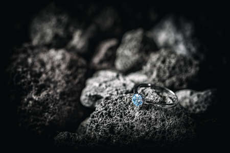 Ring with crystals on dark rock background