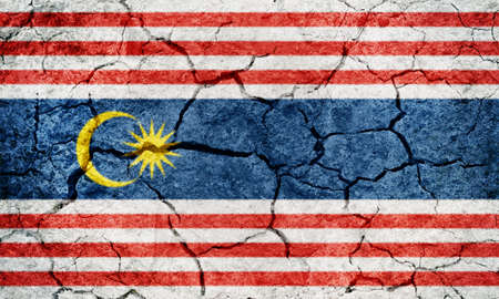 Federal Territory of Kuala Lumpur, capital of Malaysia, flag on dry earth ground texture backgroundの写真素材