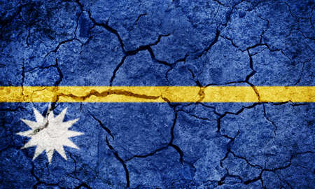 Republic of Nauru flag on dry earth ground texture backgroundの写真素材