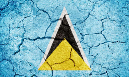 Saint Lucia flag on dry earth ground texture backgroundの写真素材
