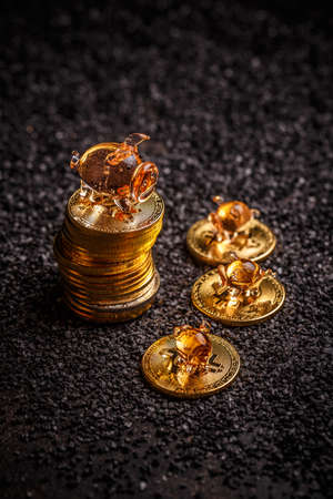 Golden bitcoin stand on pile of coinsの写真素材