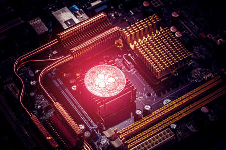 Ripple coin on a computer motherboard. New independent worldwide cryptocurrencyの写真素材