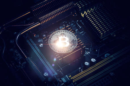 Golden Bitcoin Cryptocurrency on computer circuit board