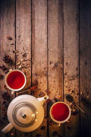 Cup of tea and teapot on rustic wooden tableの写真素材