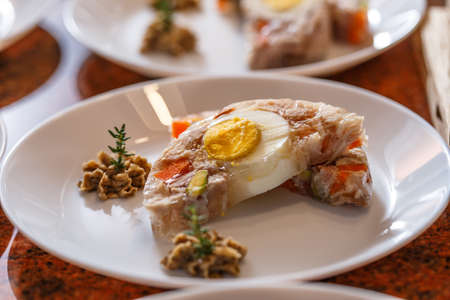 Jelly with carrots, rabbit meat and egg served with truffle spiced butter