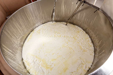 Traditional cheese making at a creameryの写真素材