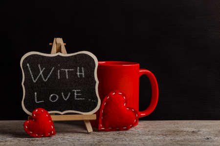 With love phrase handwritten with white chalk on blackboardの写真素材
