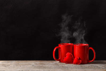 Red mugs and red felt hearts, space for your textの写真素材