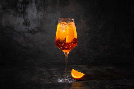 Glass of aperol spritz cocktail on black backgroundの写真素材