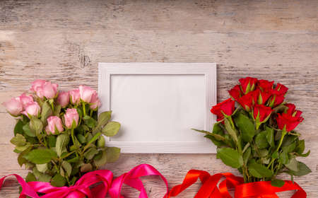Fresh rose flowers with space for your text on white wooden backgroundの写真素材