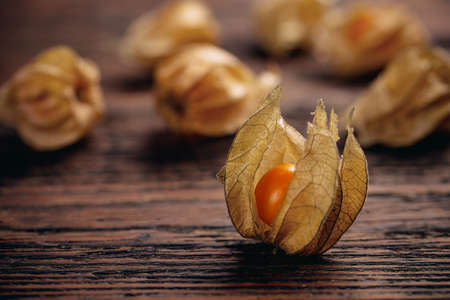 Close up of Cape gooseberry or Physalis on vintage wooden surfaceの写真素材
