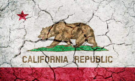 State of California flag, state in the Pacific Region of the United States, on dry earth ground texture backgroundの写真素材