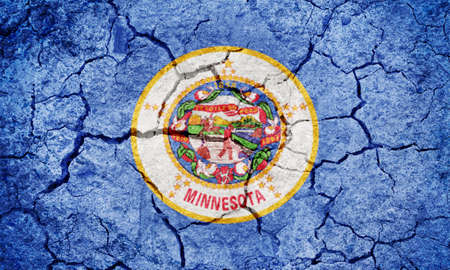 Flag of Minnesota on dry earth ground texture backgroundの写真素材