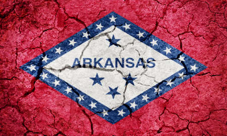 State of Arkansas flag,  state in the southern region of the United States, on dry earth ground texture backgroundの写真素材