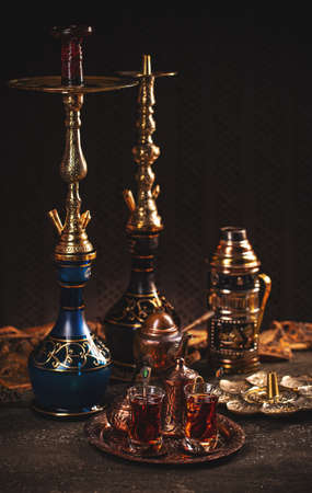 Turkish tea in traditional glasses with waterpipe