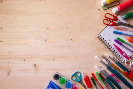 School supplies on wooden background ready for your designの写真素材