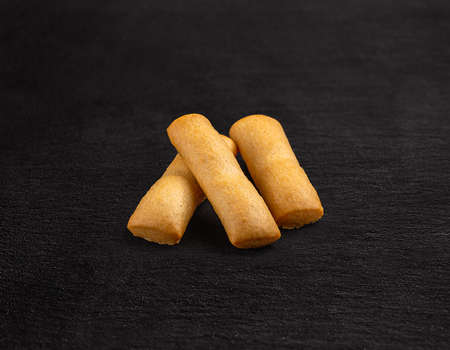 Crispy bread sticks on black background