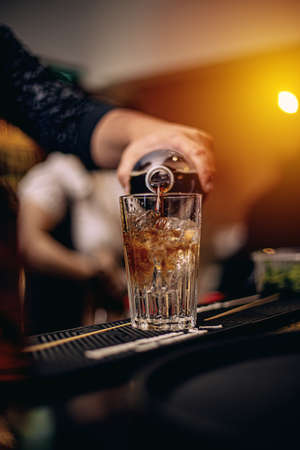 Barman at work, preparing cocktail
