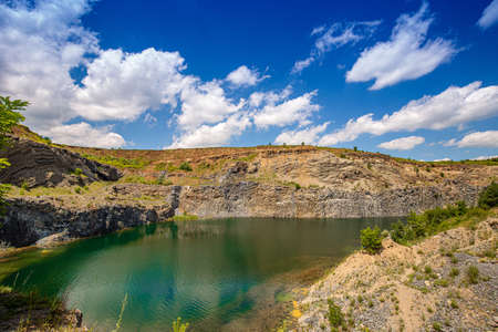 Rock shore and calm water of mountain lake