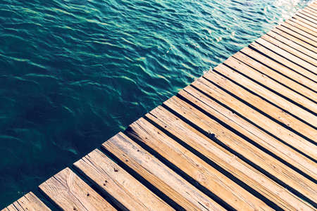 Swimming pool and wooden deck ideal for background, copy spaceの写真素材