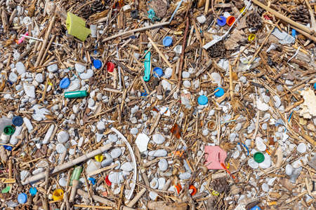 Polluted beach. Discarded plastics and wastes on a beachの写真素材
