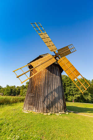 Wooden windmill. Sunny summer day at the windmill village countrysideの写真素材