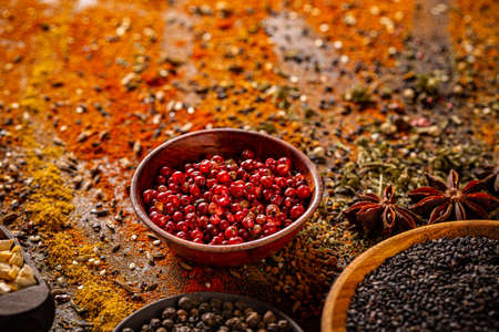 Red peppercorn in wooden bowl, spice conceptの写真素材