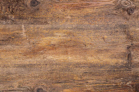 Brown scratched wooden cutting board. Wood texture