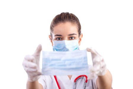 Young female doctor holding a maskの写真素材