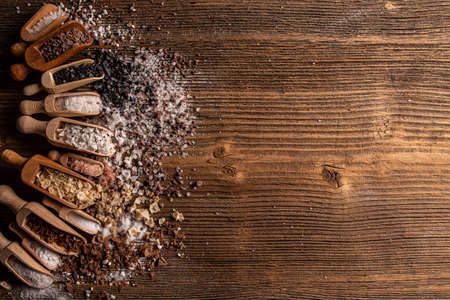 Assorted gourmet salts in scoop with copy space on wooden backgroundの写真素材
