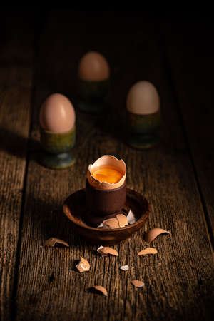 Fresh brown eggs on rustic table. Broken egg with yolk.の写真素材