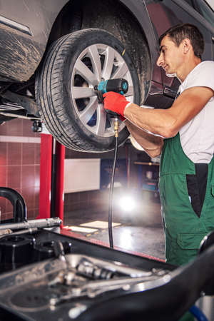 Mechanic in uniform is workingの写真素材