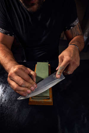 Hands sharpening Japanese chef knifeの写真素材