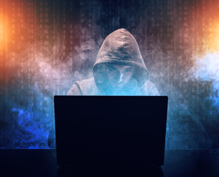 Hacker in front of his laptopの写真素材