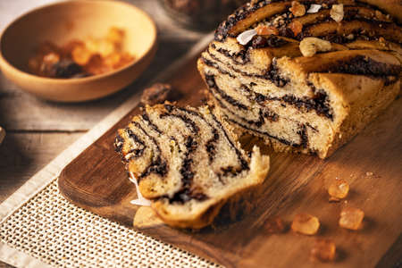 Traditional Polish vegan babka cake with chocolate on wooden background