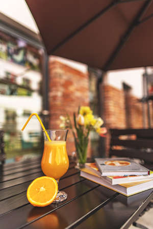 Glass of freshly squeezed orange juice on a restaurant terraceの写真素材
