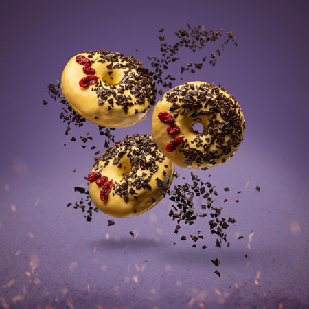 Flying donuts. Doughnuts with sprinkles on purple backgroundの写真素材