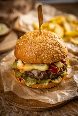 Fresh tasty beef burger on wooden tray on the tableの写真素材