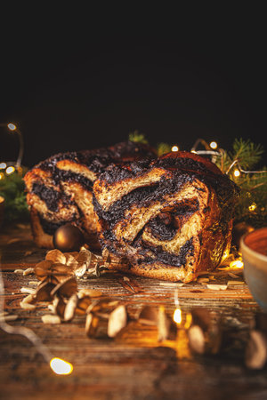 Soft sweet yeast dough with poppy seed filling on Christmas background. Babka conceptの写真素材