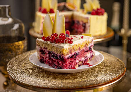 Slice of summer sponge cake with vanilla cream and fresh berries.