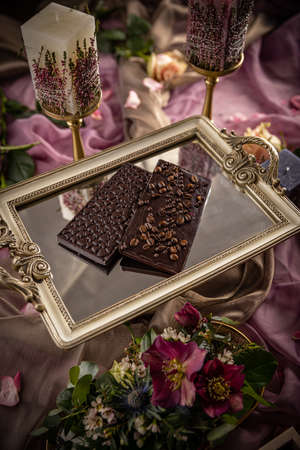 Chocolate bars with coffee beans, heart shapes on the top, still life for Valentine day