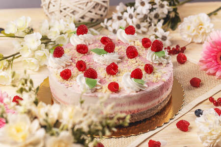 Still life of raspberry cream mousse cake decorated with fresh raspberriesの写真素材