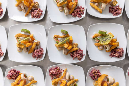 Top view of food appetizer arranged on a white plate