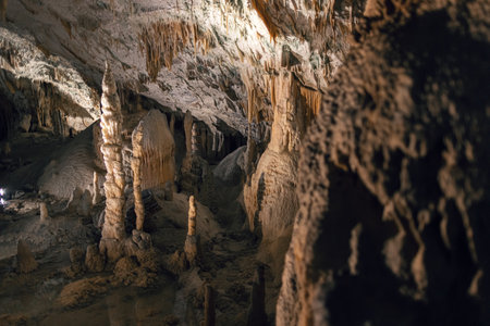 Illuminated dropstones, stalactite and stalagmite mineral formation in cavesの写真素材