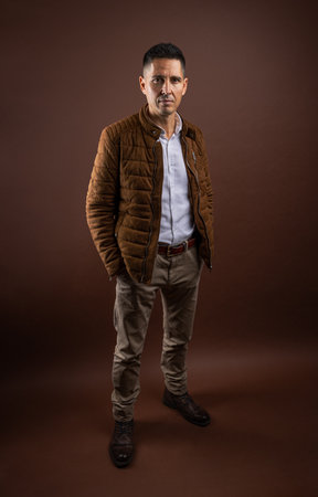 Male portrait concept. Portrait of a mature businessman on brown background.の写真素材