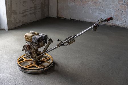 Concrete floor finishing on construction site. Concrete screed with power trowel machine